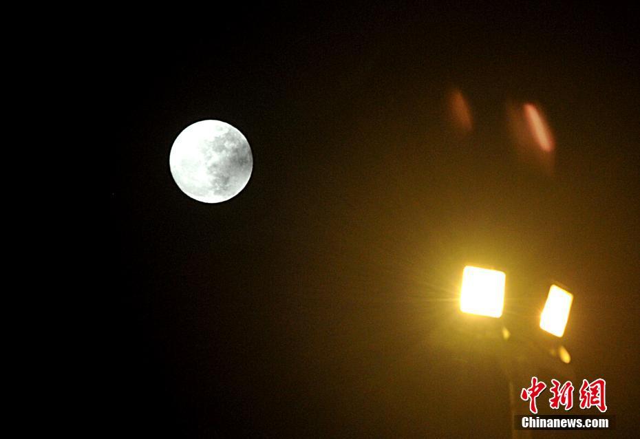 12月13日晚，福州上空拍摄的“超级月亮”。当日，继今年10月17日和11月14日之后，“超级月亮”12月13日晚再次现身天宇。中新社记者 张斌 摄