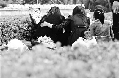 塘沽烈士陵园内，几位家属在墓碑前诉说思念之情