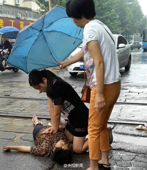 90后女护士雨中跪地救人 膝盖磨破全身泥水
