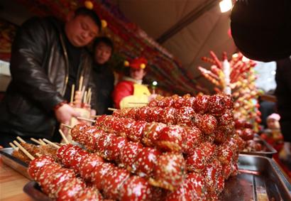 红灿灿的糖球勾起众多游客的食欲