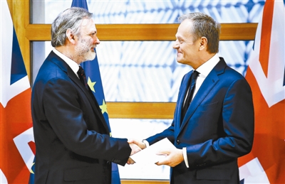 3月29日，在比利时布鲁塞尔，英国驻欧盟大使蒂姆·巴罗（左）将“脱欧”函递交欧洲理事会主席图斯克 供图/新华社