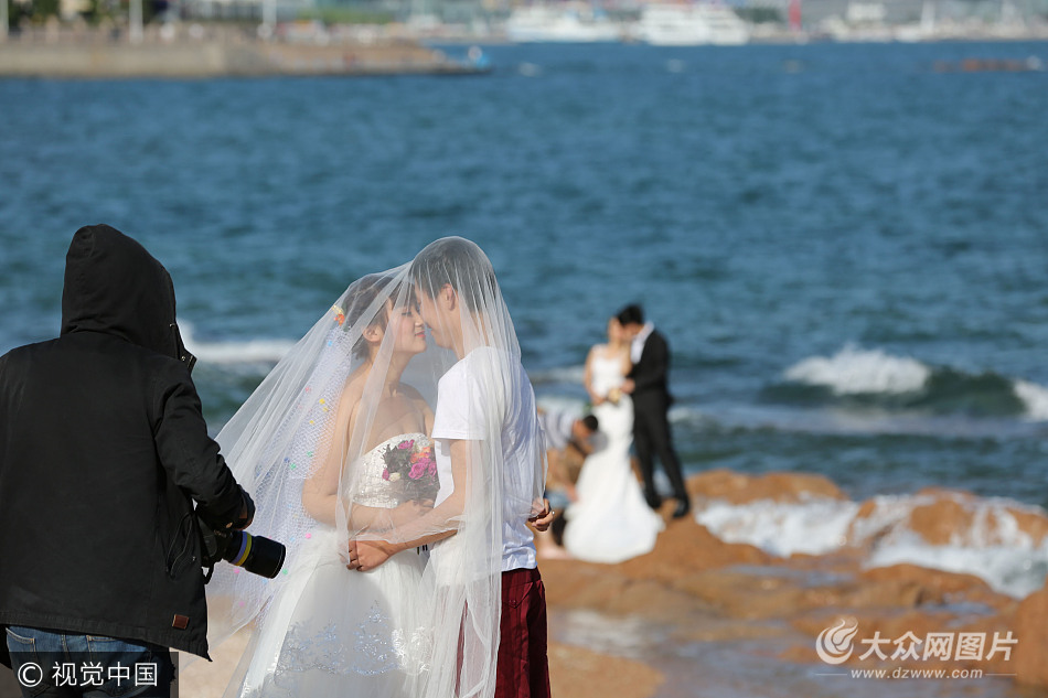 众新人扎堆青岛海水浴场拍摄婚纱照