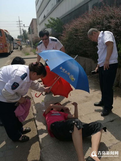 女子醉酒睡马路边 公交司机为其撑伞遮阳